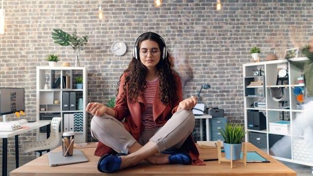 woman practicing meditation at her work break