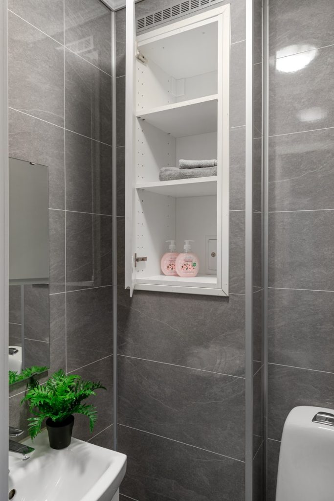 Mistakes to Avoid When Building a Shower Niche Shelf 1 A white toilet sitting next to a white sink