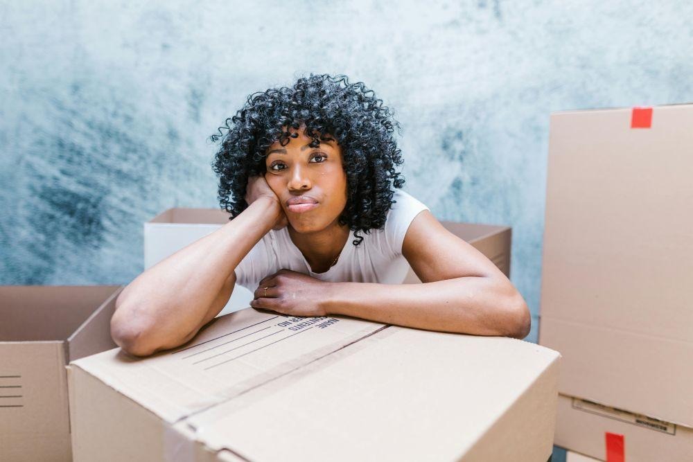 How to Time an Office Move in Ohio Around Seasonal Business Cycles (And Why It Matters) 4 A woman resting her arms on boxes