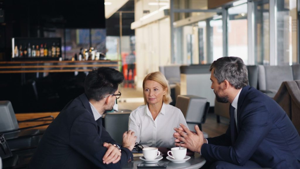Customer Relationship Management Tips for Sustainable Growth 1 a group of people sitting around a table talking