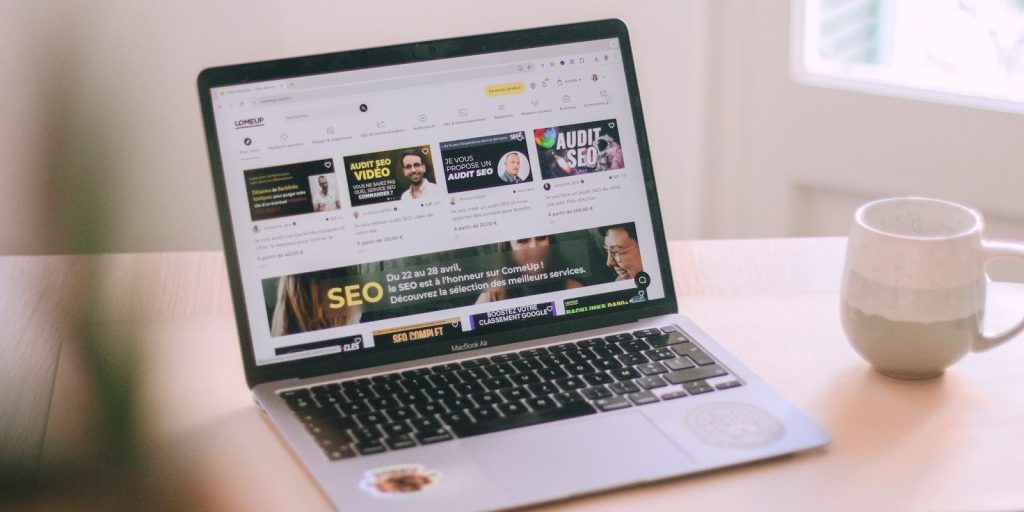 8 Strategies You Can Use to Grow Your Brand Online 1 A laptop computer sitting on top of a wooden table