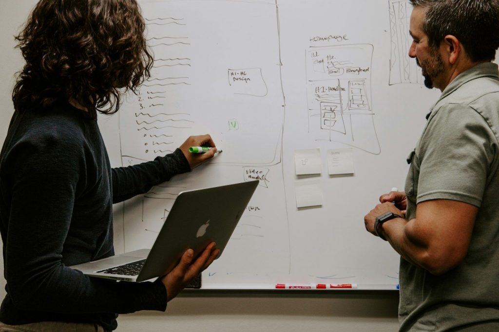 Three Tips for Your Business Localisation Strategy 7 man wearing gray polo shirt beside dry-erase board