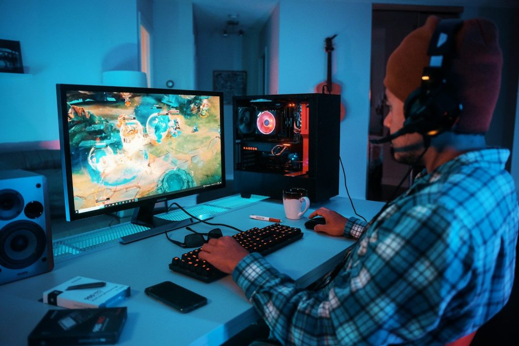 5 Skills Where Business & Gaming Overlap 4 a person wearing headphones and using a computer