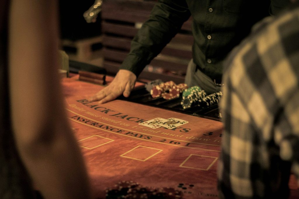 The Impact of Online Casinos on the Philippine Economy 5 man in green dress shirt sitting on chair