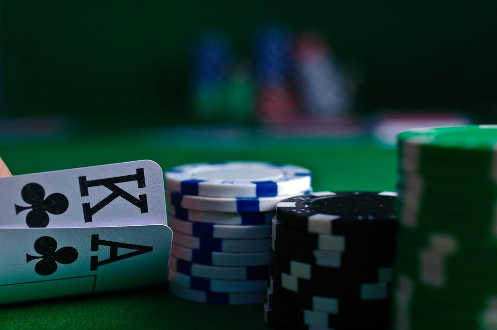 How To Stay Safe While Playing Pokies? 1 white and black dice on green table